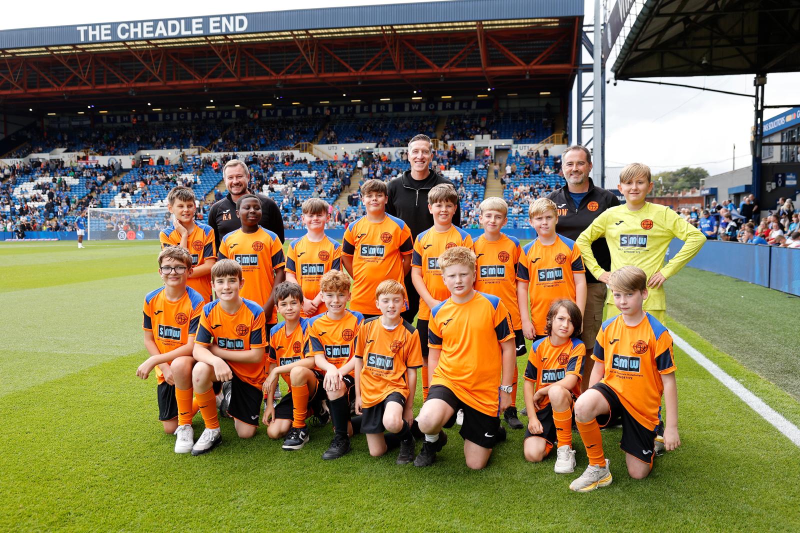 Young High Lane footballers training together on a grass pitch